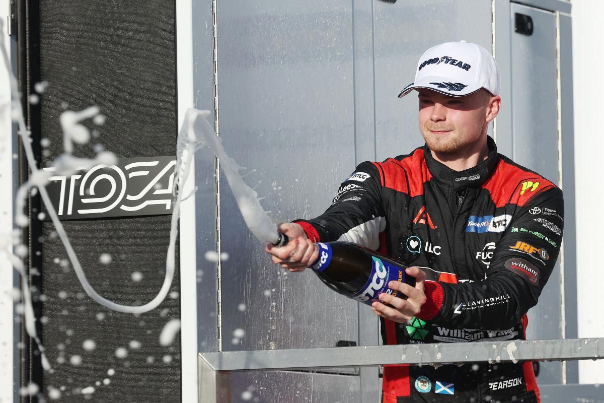 Driver spraying champagne on the podium
