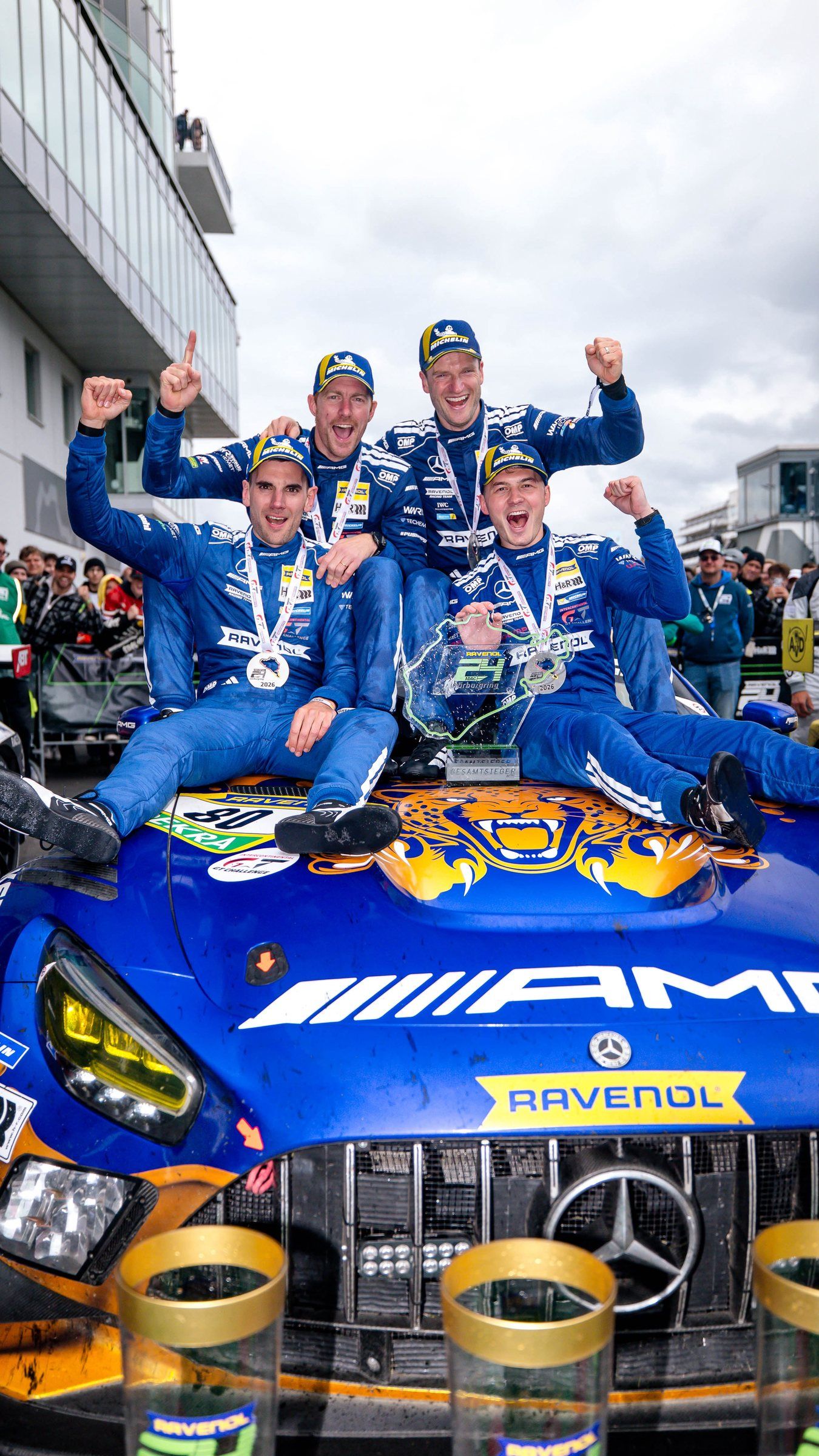 Maro Engel and his Mercedes-AMG team-mates celebrating on top of their car